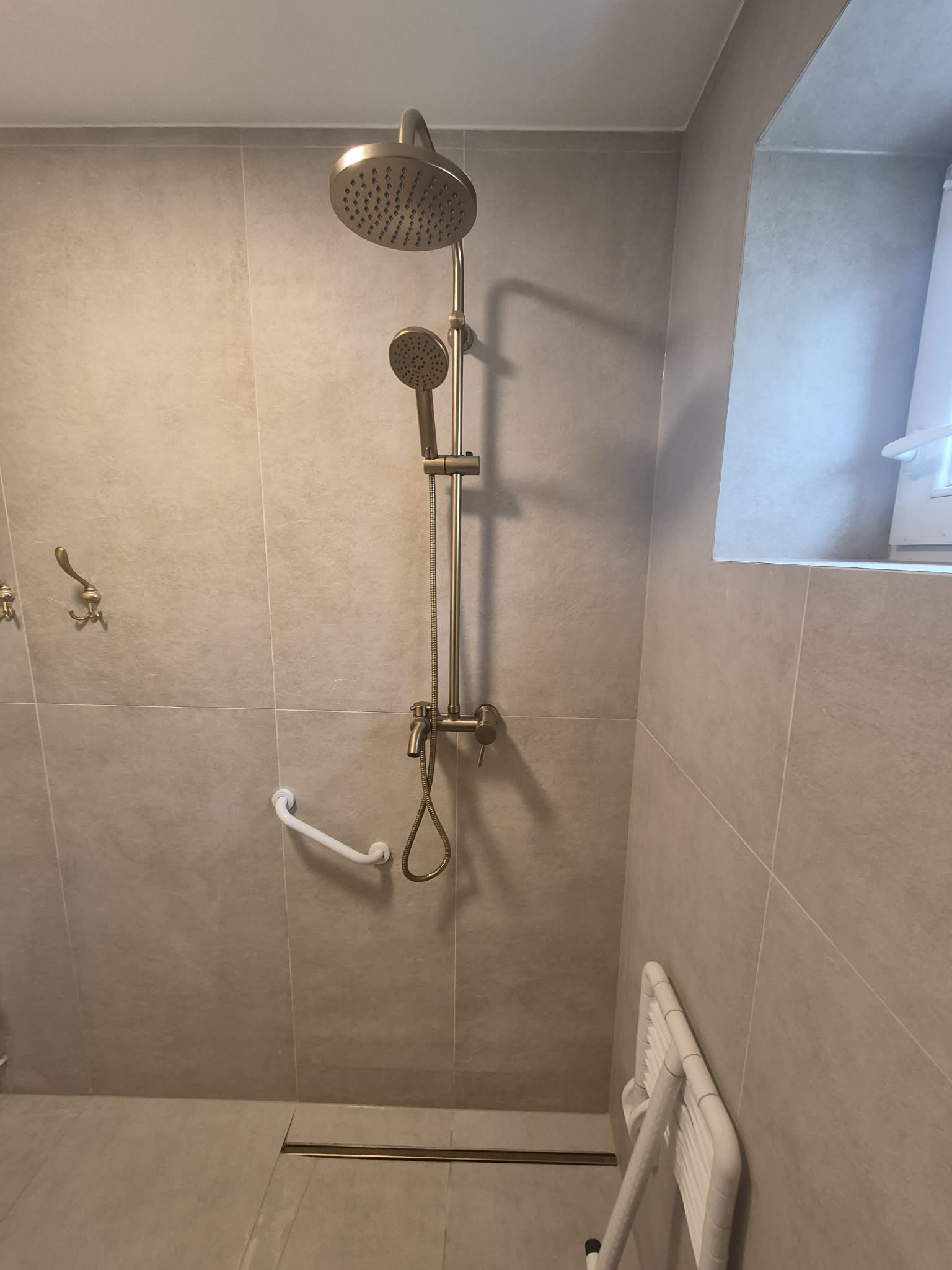 Remont łazienki, realizacja AquaMaster — prysznic z deszczownicą i baterią w kolorze złota